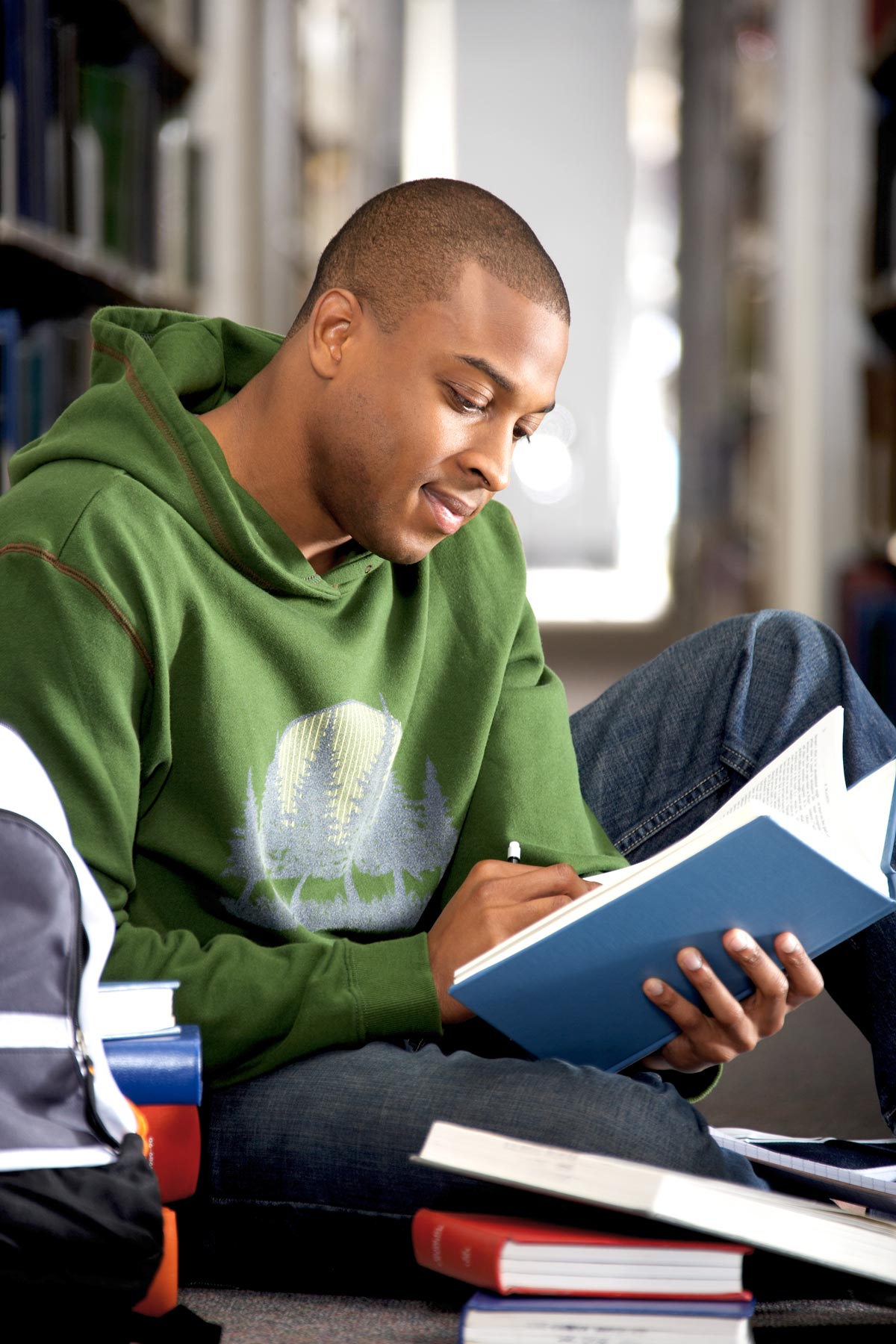student reading a book in the library