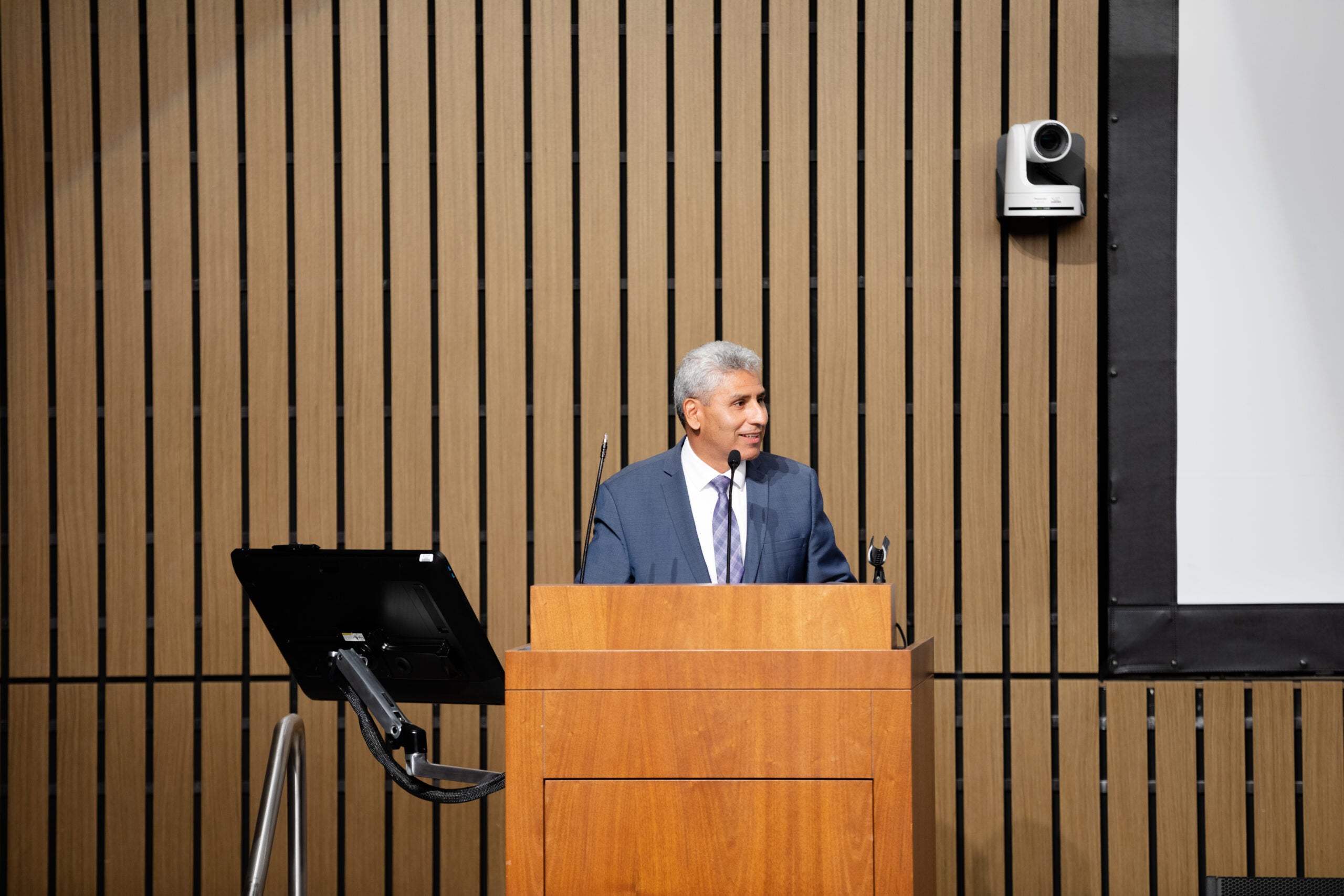 Chancellor Juan Salgado speaks to the crowd at the podium.