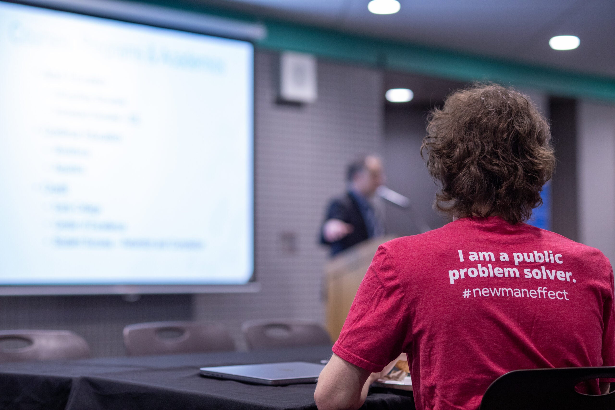Student wears a t-shirt that reads "I am a public problem solver."